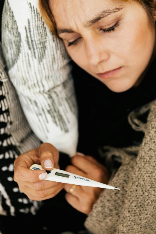 a woman leaning down looking at a tweet