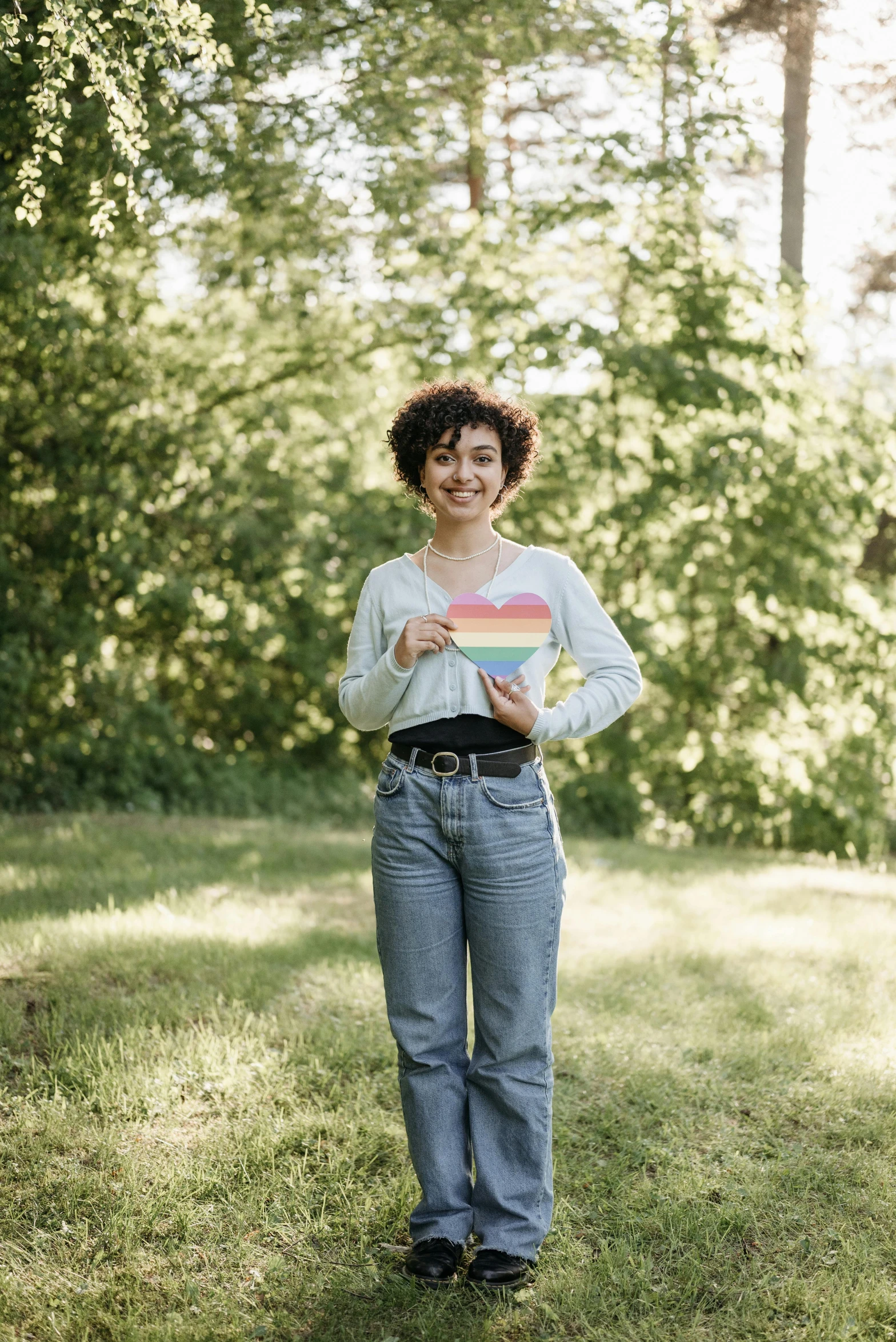 a woman smiles and shows off her pink and blue shirt