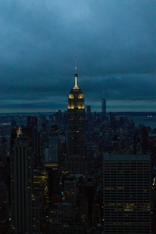 the top of a skyscr is lit up at night