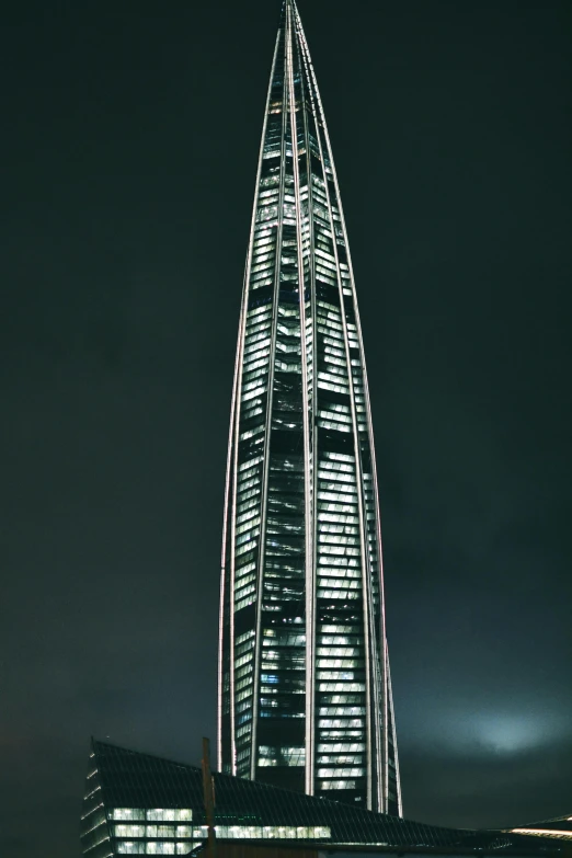 a tall building with lots of lights around it