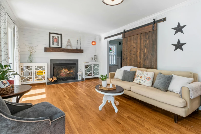 a living room with a white wall and fireplace