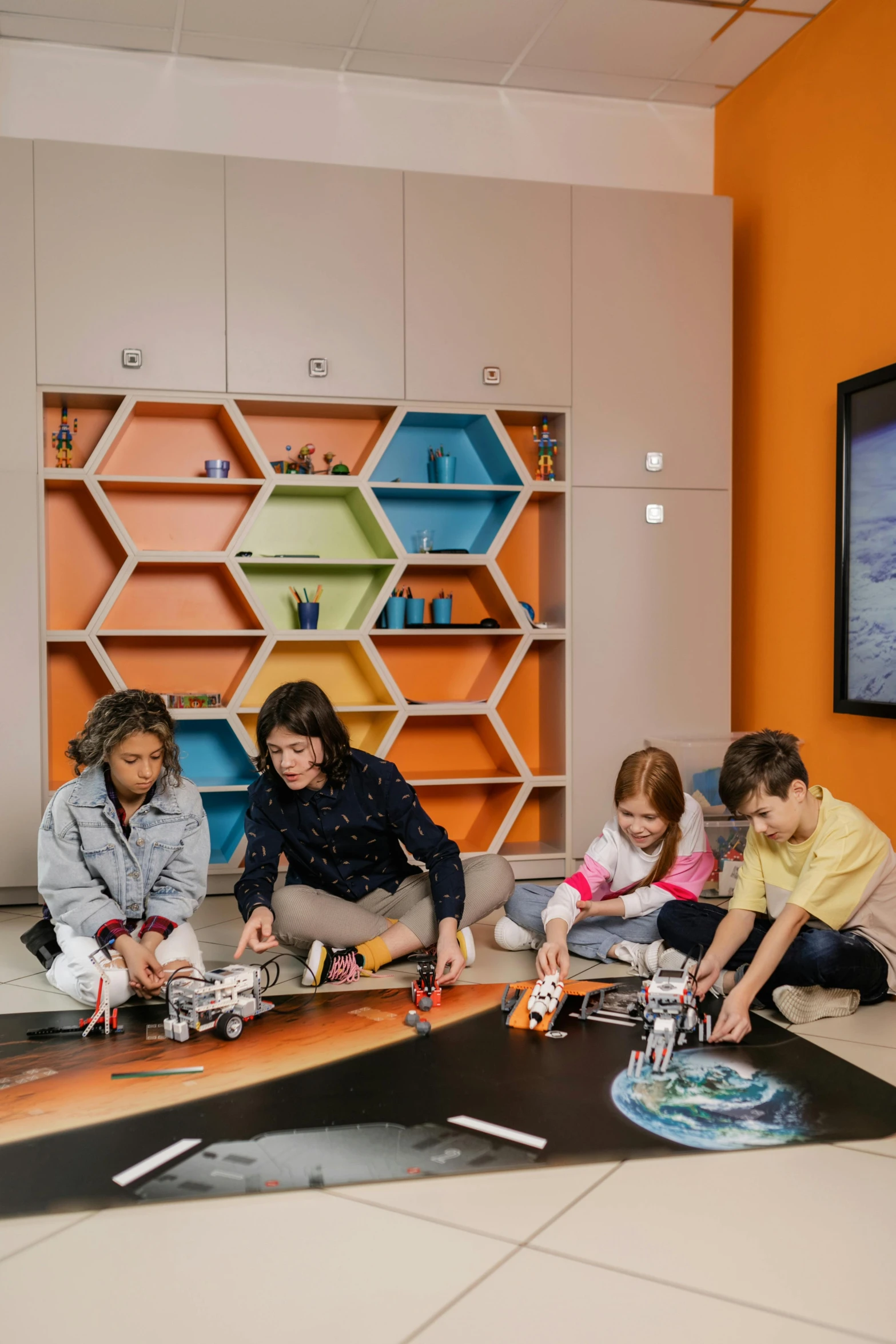 a group of children working on a piece of architecture