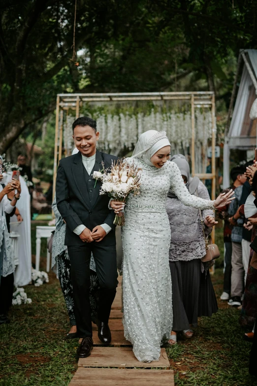 a newly married couple walks down the aisle