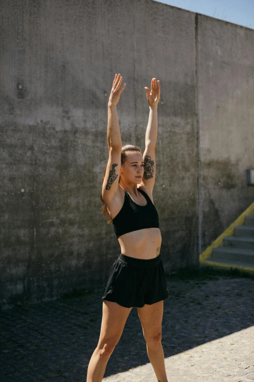 a female wearing black is doing a yoga dance