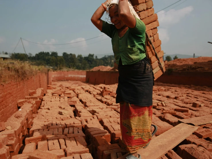 a woman standing on top of a brick block structure