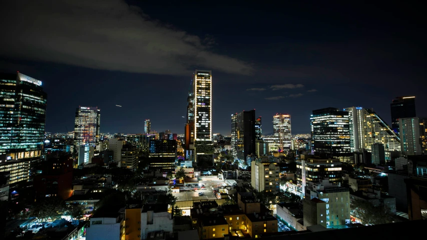 a night scene in a big city with lots of tall buildings