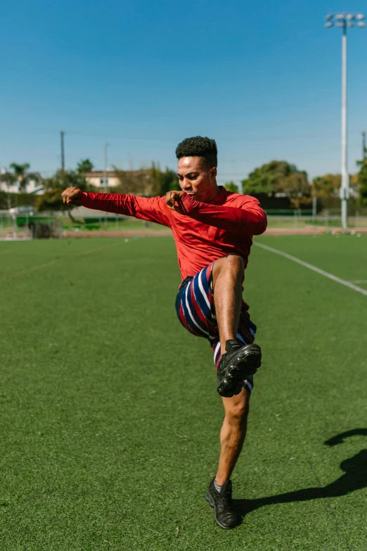 a man on a field kicking a soccer ball