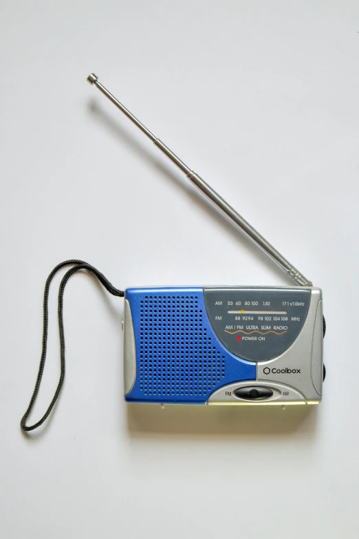 an old style radio player is laying beside a tiny antenna