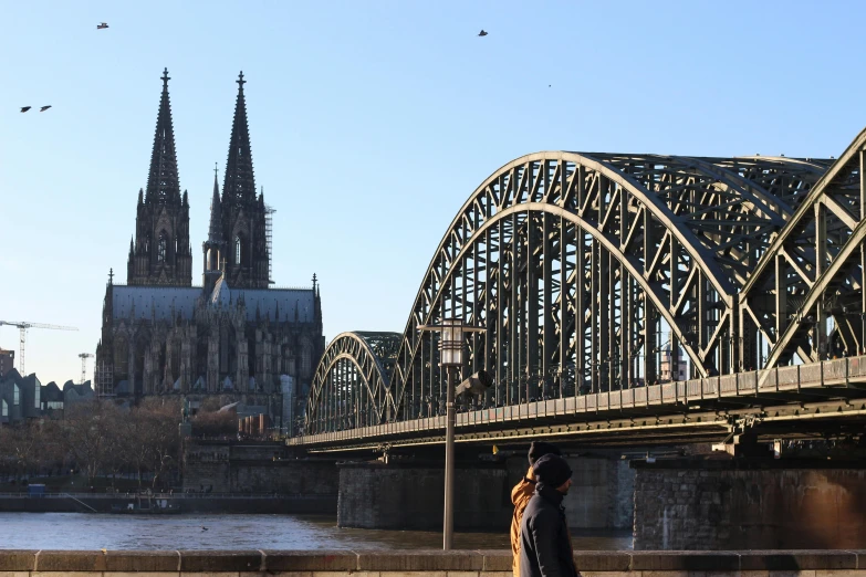 a person standing on the bridge over the water