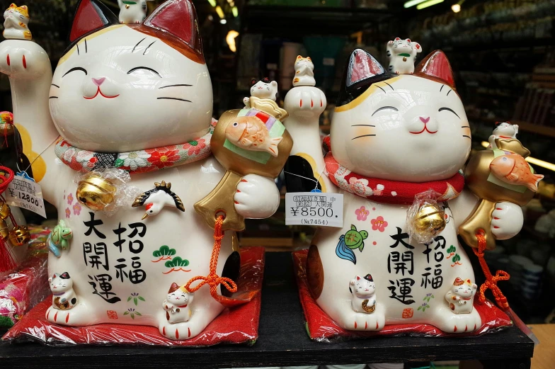 two cat figurines sitting on top of each other