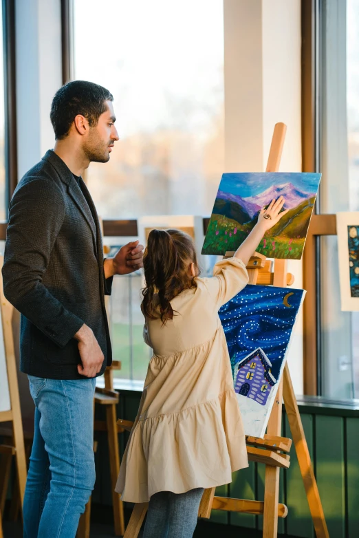 two people in a room painting an art piece