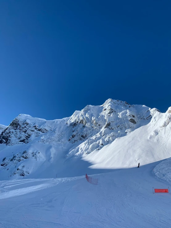 someone on skies in the mountains going down the slopes