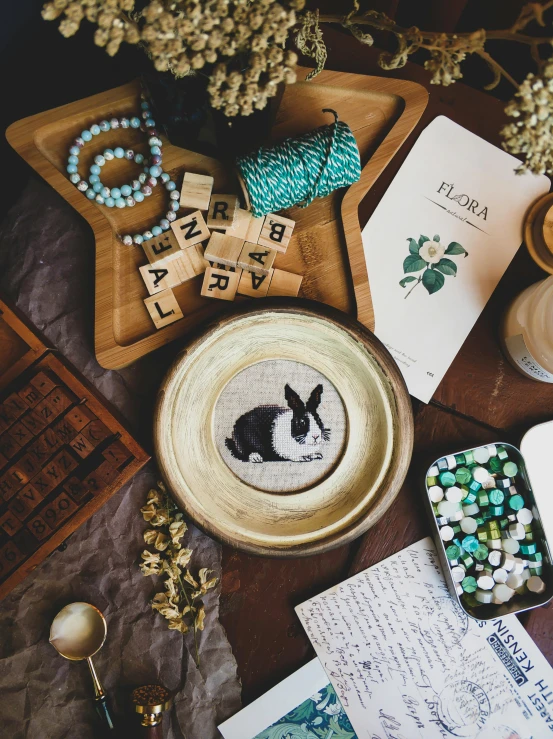 a crafting table with different items on it including beads, paper and scissors