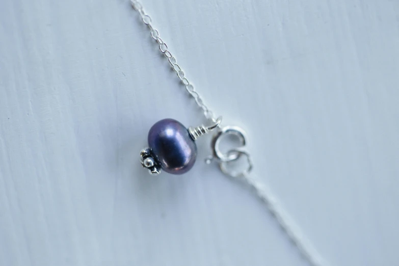 a close up of a blue pearl necklace