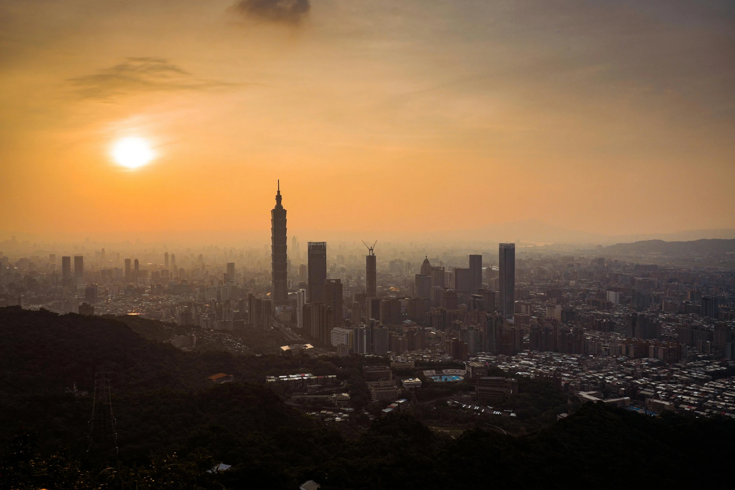 the sun is setting over a city