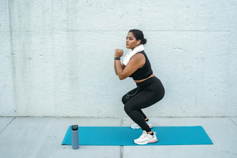 woman doing exercises on her fitness mat outdoors