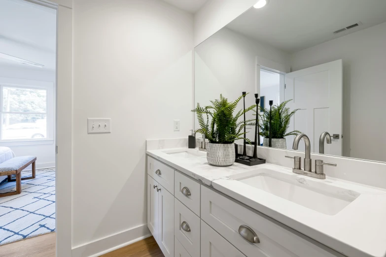 a bath room with a big mirror and sink