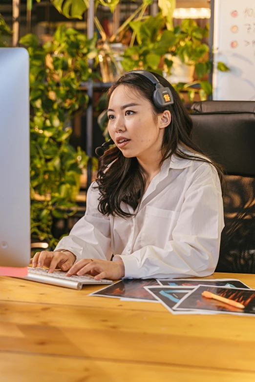 a woman is at a desk and looking around her