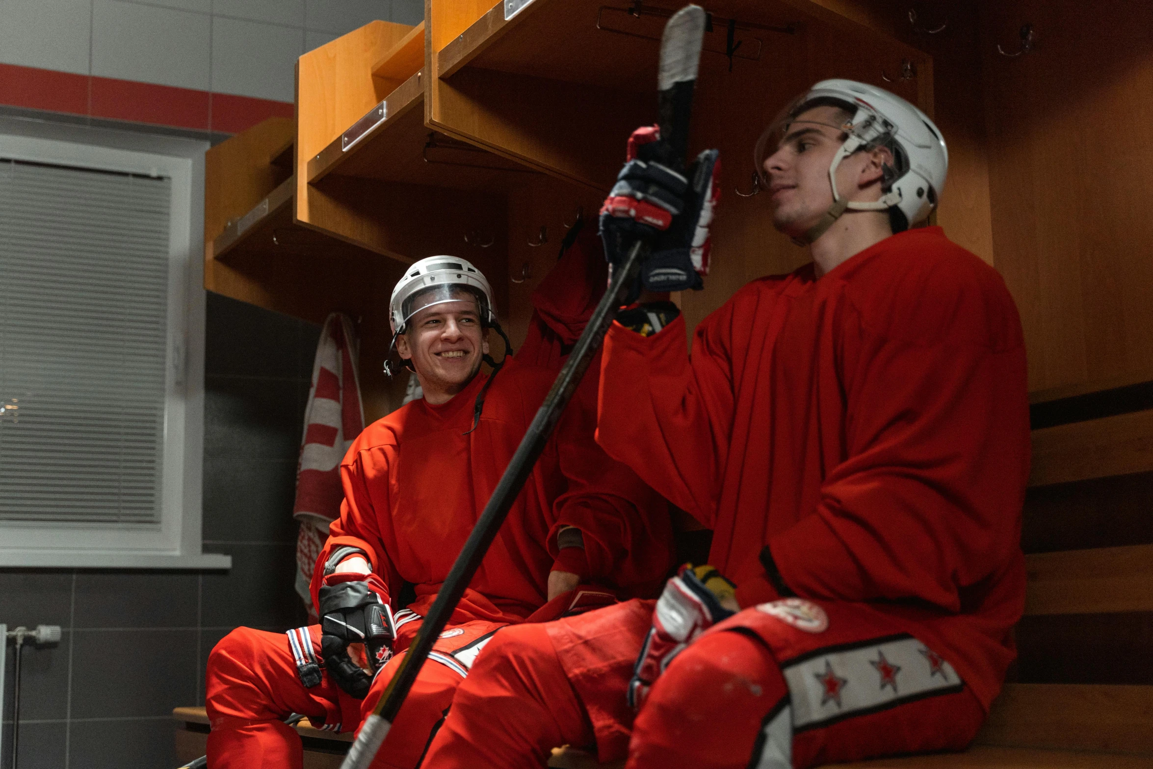 the two young men in red are wearing matching costumes