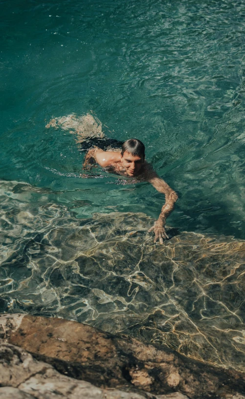 a man diving off the side of a boat