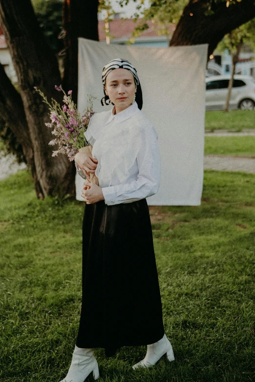 a woman is holding a vase and posing for a po