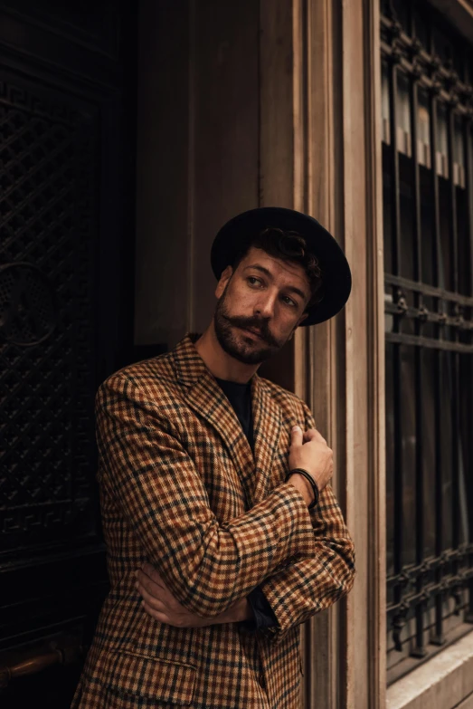 a man is standing outside the door of a building