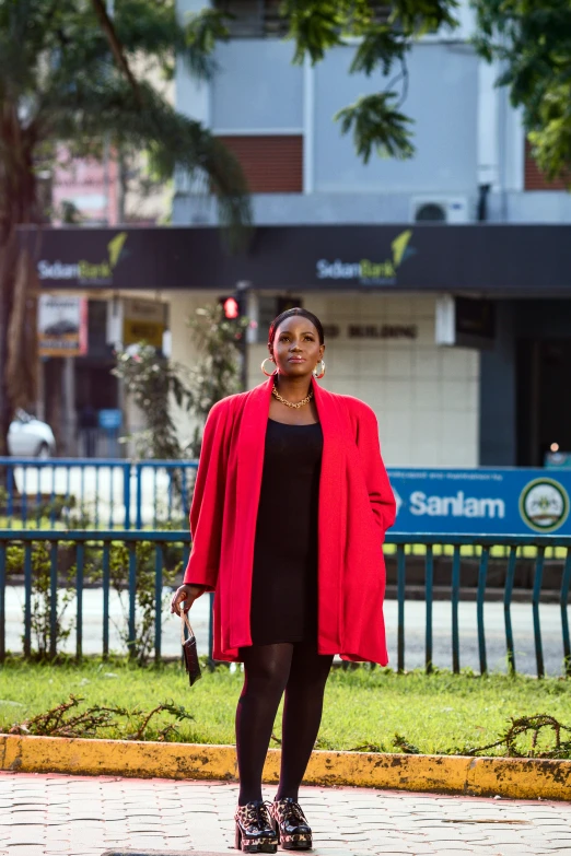a woman standing outside in a red coat