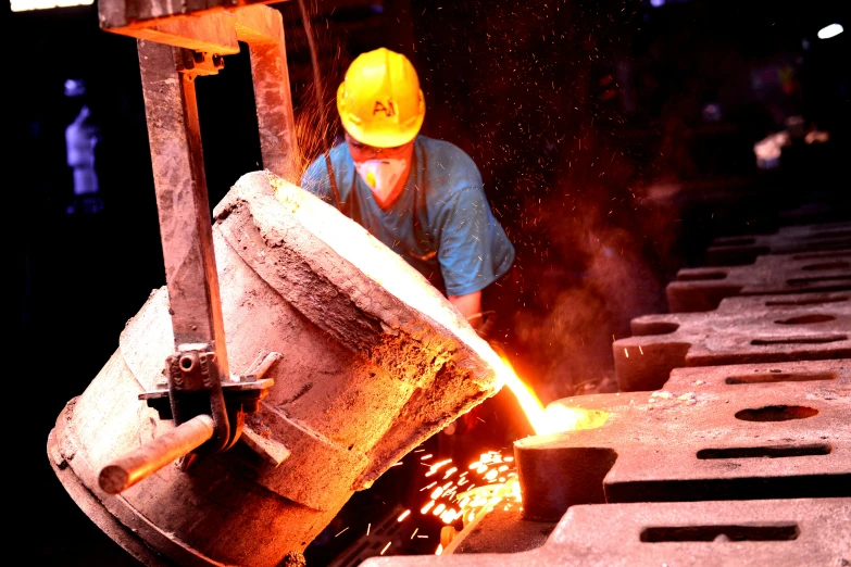 a man in safety gear welding soing metal