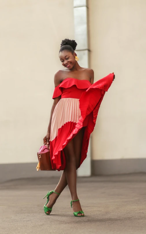 an african american woman walking in a red dress