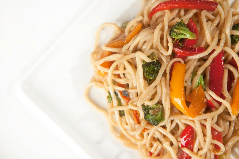 a pasta dish served with broccoli and red peppers