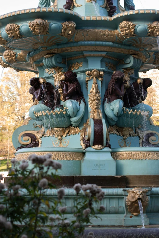 a fountain that has sculptures on the sides