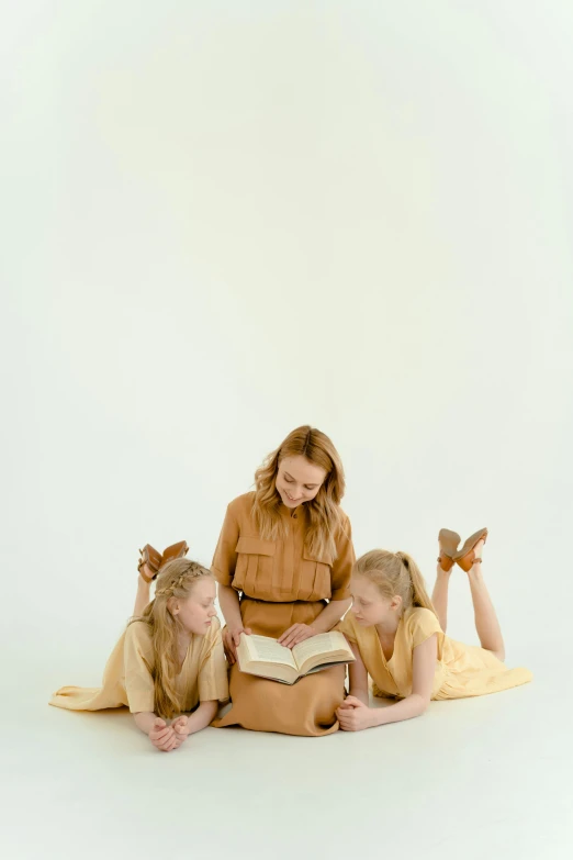 three s reading a book and smiling