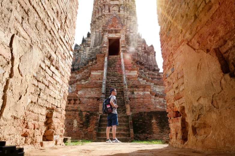 a guy standing in front of a very tall tower