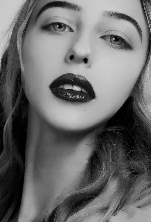 a beautiful blond with black lips posing for the camera