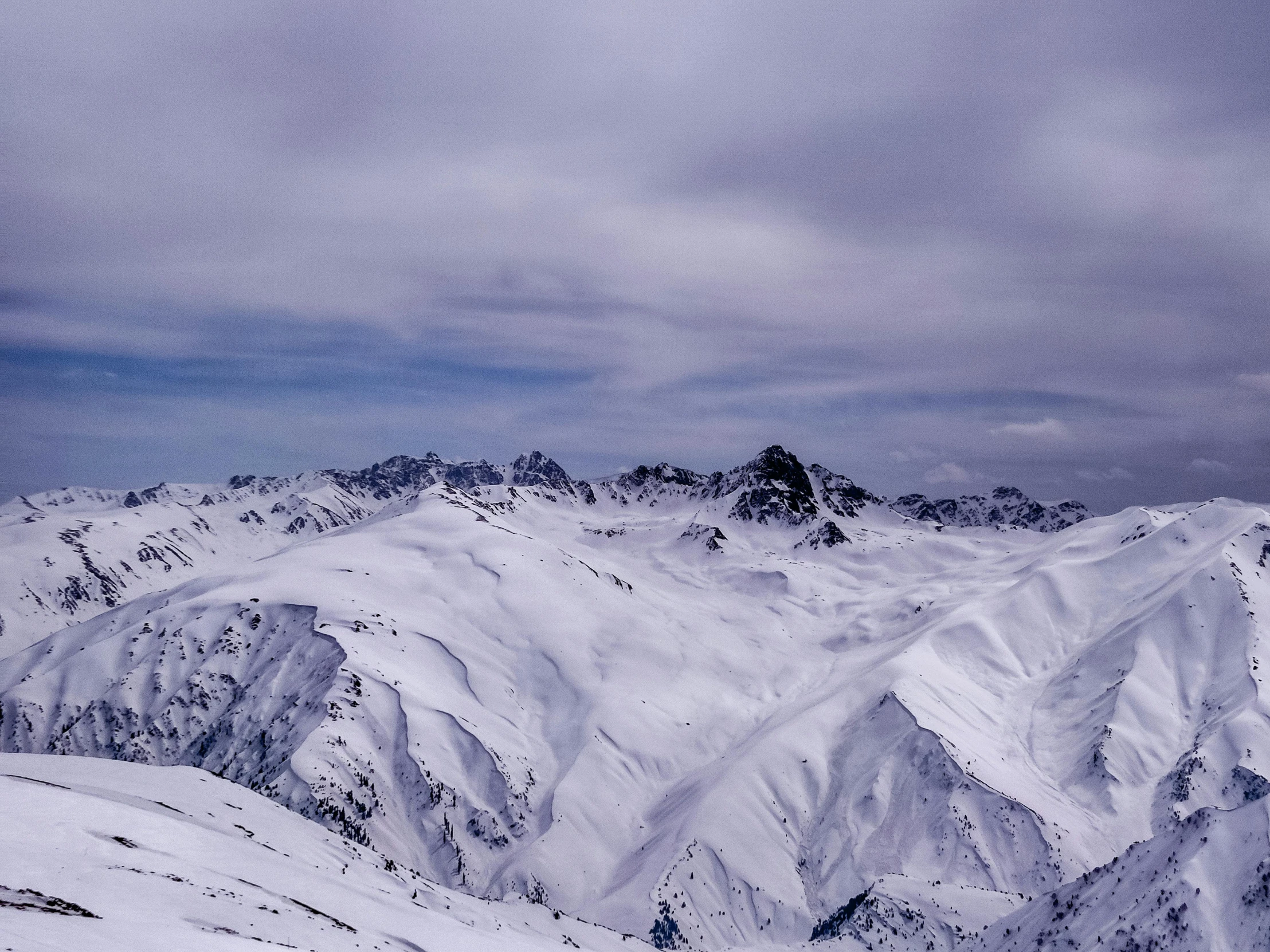 a view of a mountain range covered in snow