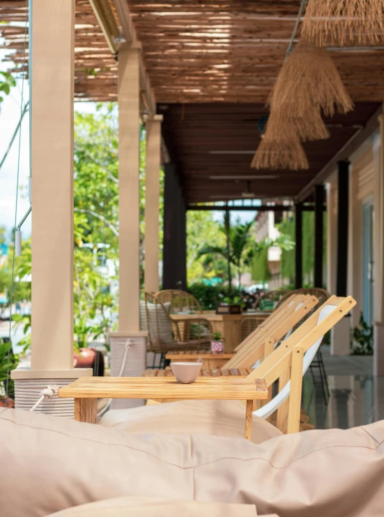 the view from a patio with lounge chairs and tables