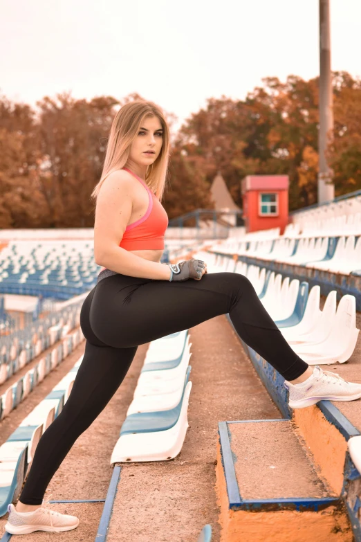 there is a woman posing on the bleachers