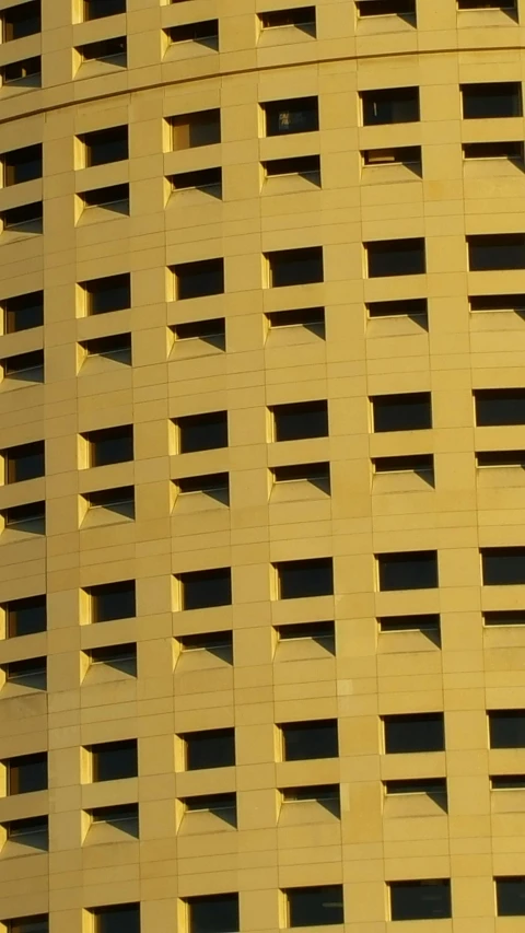 a bird is perched on the side of a tall building