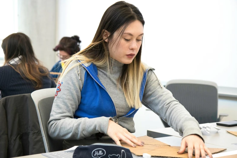 a student working on her work at the back of the room