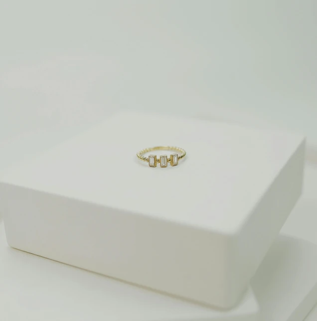 a ring sitting in a white box on a table