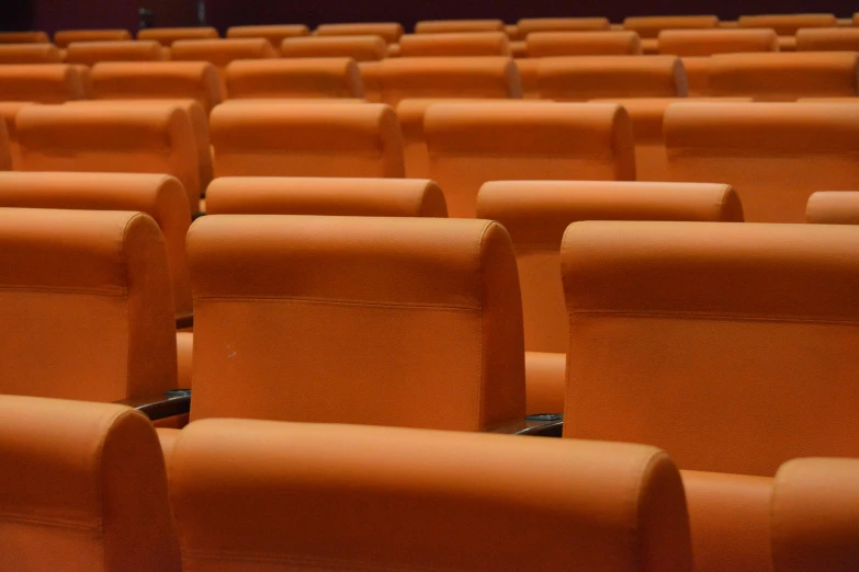 many chairs that are close together with a light on