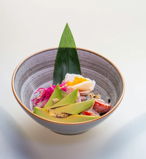 a small bowl full of various vegetables and fruit