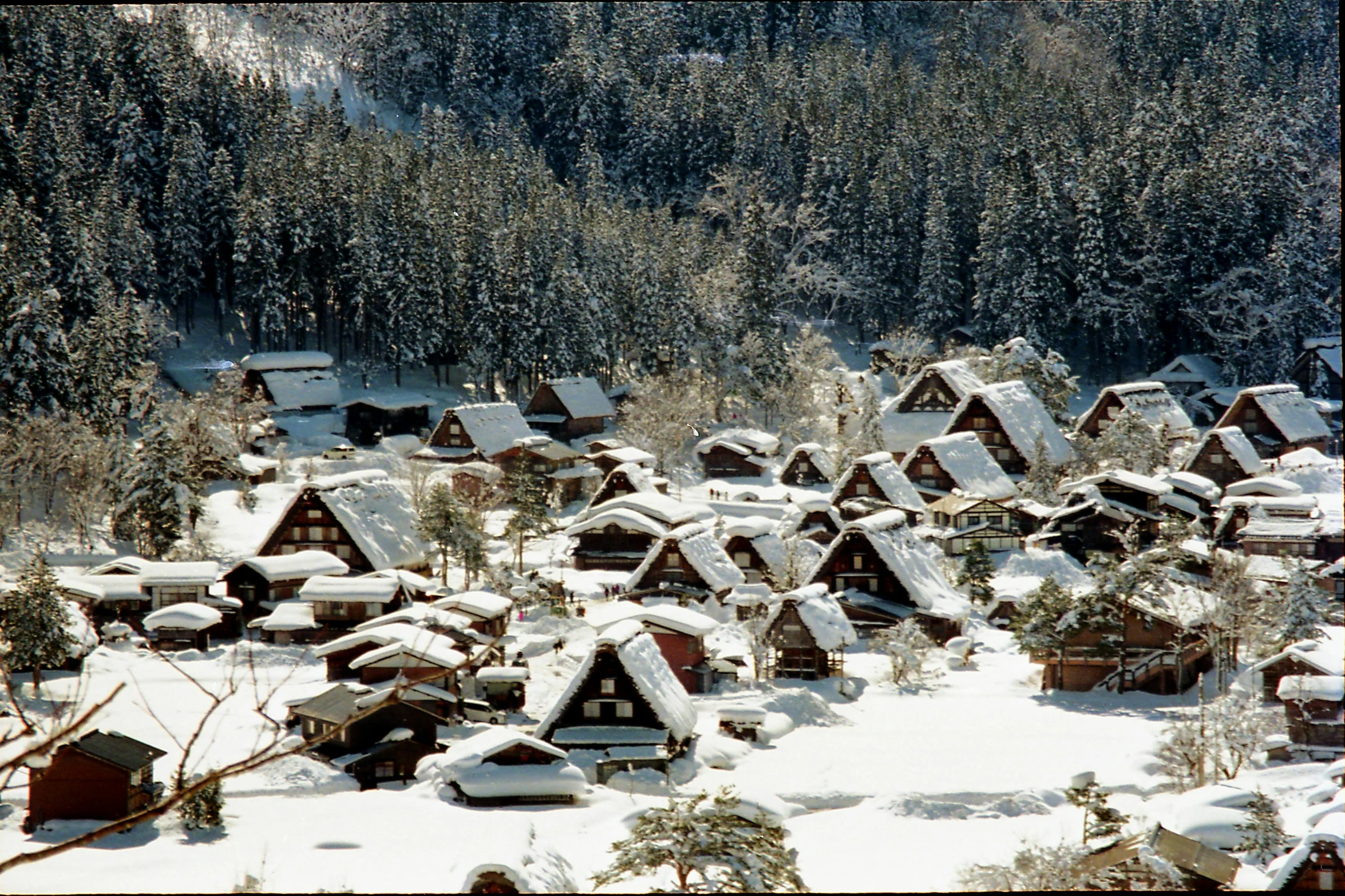 small, rustic log - home buildings in the middle of the snow