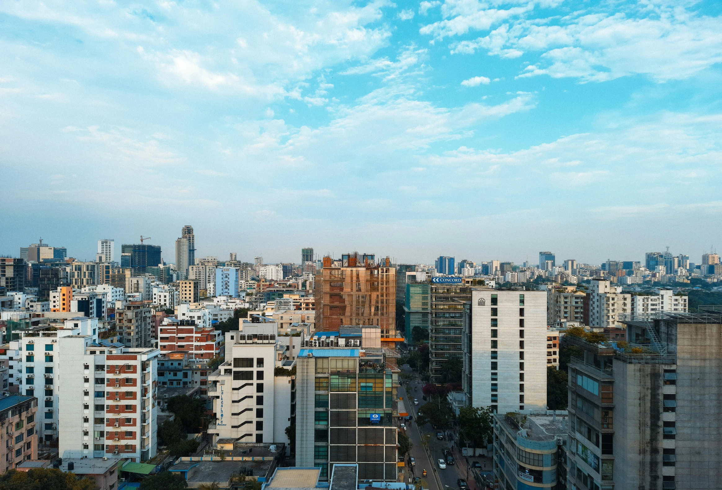 an urban cityscape is pictured against the cloudy sky