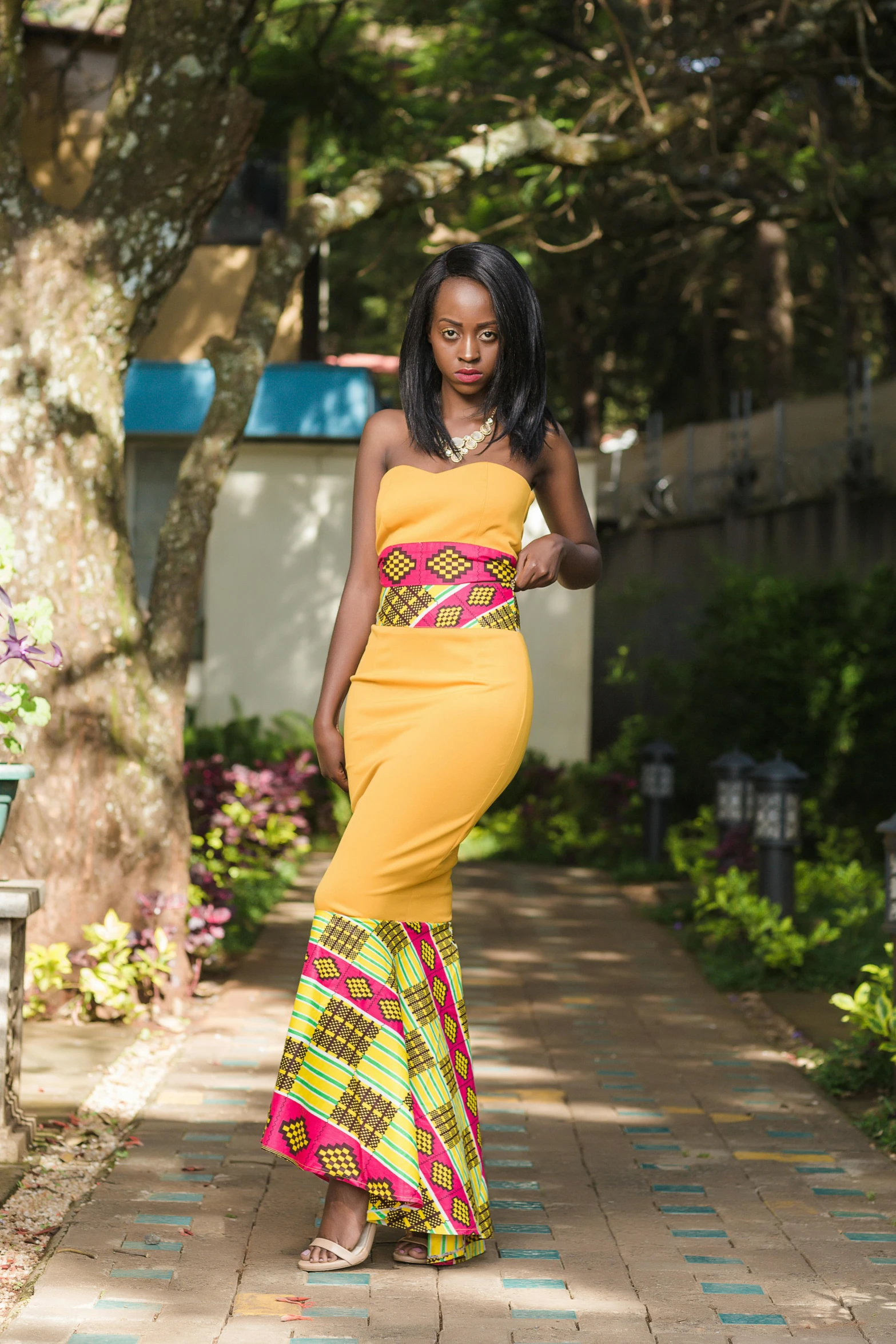 the young woman is dressed in a bright yellow gown