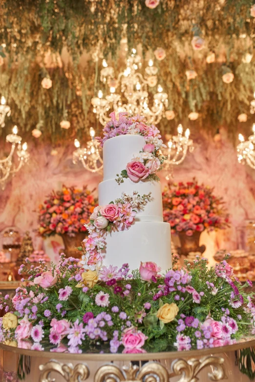 a wedding cake with a lot of flowers on the bottom of it