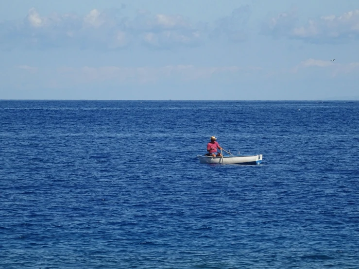 an image of a man paddling in the ocean