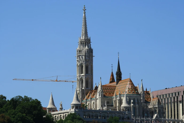 some buildings are under construction as a crane works on the roof