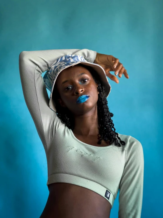 a young lady posing with blue lipstick on her face