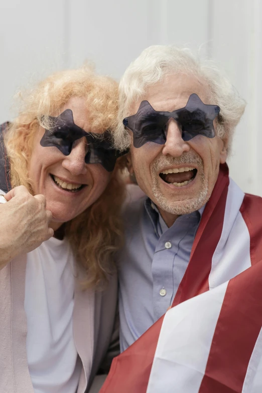 two people with shades that have the american flag on their faces